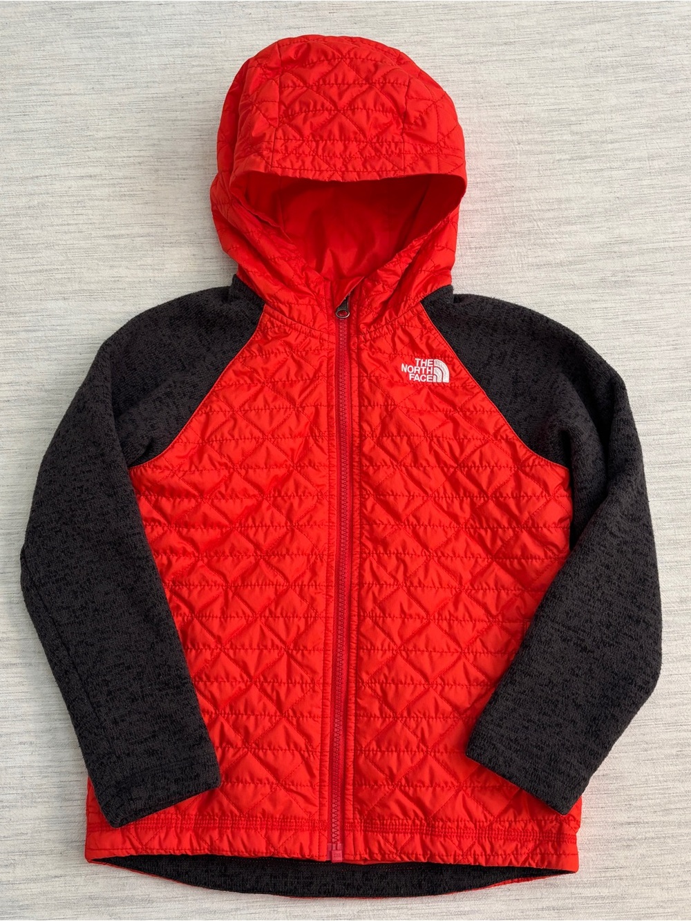 The North Face kids Red Quilted Hooded Jacket with Black Raglan Sleeves